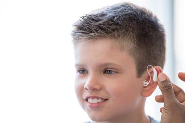 pediatric-hearing-aids-r Child being fit for a hearing aid